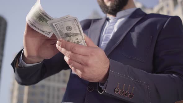 Unrecognizable Bearded Man in Suit Scattering Money and Laughing. Successful Happy Middle Eastern