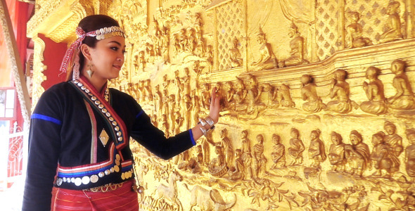 Girl With Traditional Clothes Touching Temple Wall