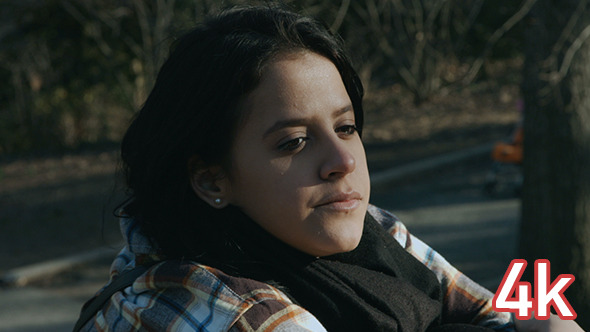 Girl Sitting and Looking Around in Central Park