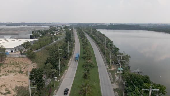 Traffic and big trucks on the road at Amata City Rayong Industrial Estate