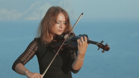 Beautiful Violinist In Tracery Dress Plays On a