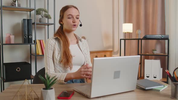 Woman with Headset Using Laptop Talking Working Customer Support Service Operator at Home Office