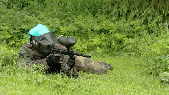 A Man Eyeing for an Enemy with a Paintball