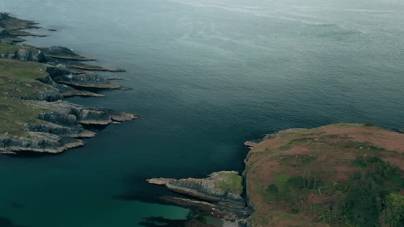 Aerial forward tilt of the Atlantic Ocean entrance into Irish coast, West Cork feeding Lough Hyne wi