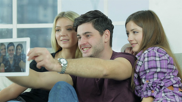 Guy And Two Girls Make Selfie With A Tablet