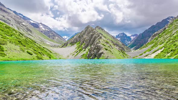 Clouds over a turquoise mountain lake