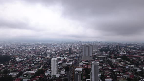 High altitude aerial shot of skyscrapers in San Jose during a storm, Costa Rica