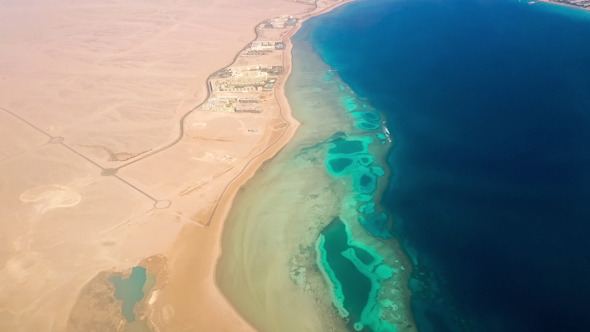 Aerial View from the Aircraft to Desert and Sea