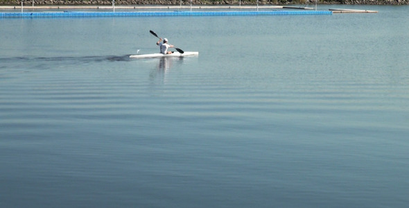 A Man Swims on a Kayak alt