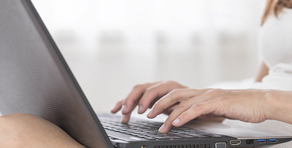 Woman Work at Laptop in Bedroom