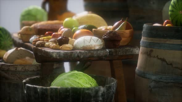 Food Table with Wine Barrels and Some Fruits Vegetables and Bread