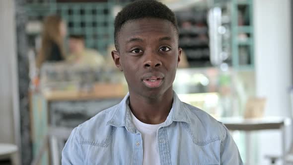 Portrait of Young African Man Shaking Head As No Sign