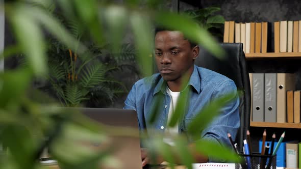 Adult African American Man Freelancer Works for Laptop Typing Text on Keyboard