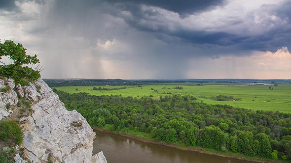 Landscape With River And Rain On Horizon