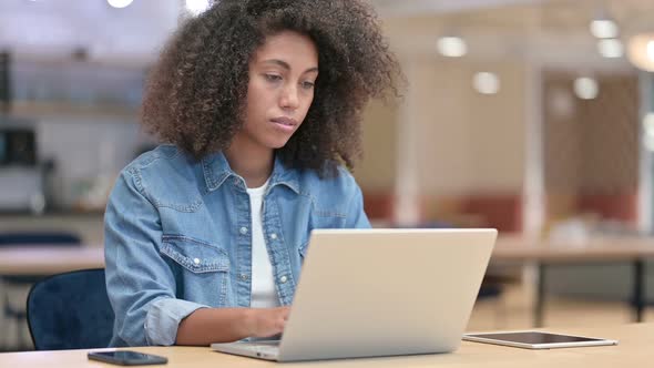 Online Payment Success on Laptop for Young Latin Woman in Cafe