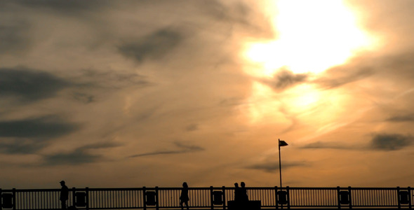 People Silhouette on Bridge and Sunset