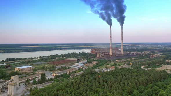 Industrial zone in countryside. Air pollution by smoke coming out of two factory chimneys