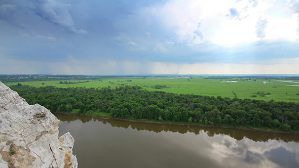 Landscape With River And Rain On Horizon