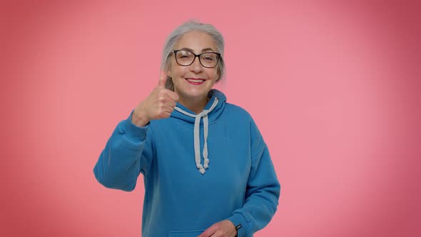 Senior Old Granny Woman Pointing Down Saying to Subscribe Gesturing Ok and Like Information Below