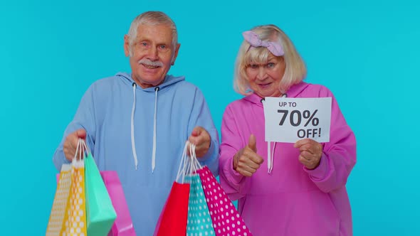 Senior Grandparents Holding Shopping Bags and Up To 70 Percent Off Banner Text Black Friday Holiday