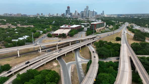 Population and traffic growth in Austin Texas. City skyline in distance. Aerial pullback reveal of b