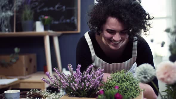 Florist enjoying the smell of blooming flowers