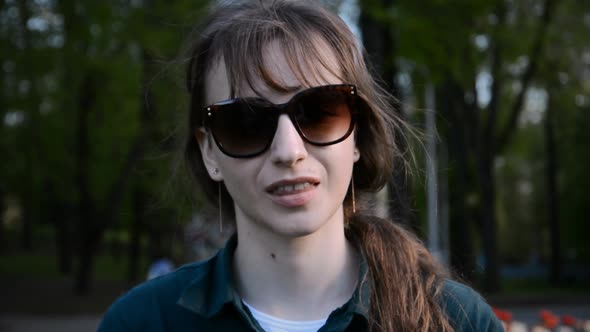 Young Beautiful Girl in Sunglasses Evening Portrait