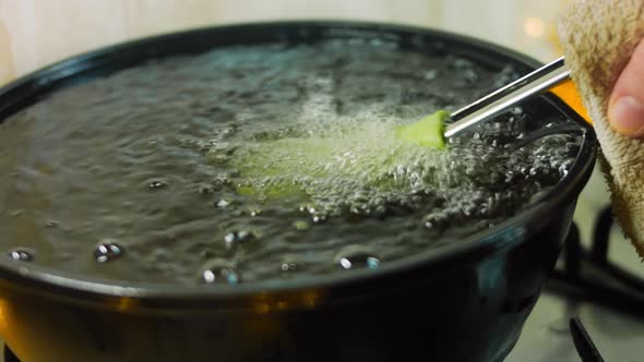 The Chef Bakes Green Tortillas in a Bowl with Oil