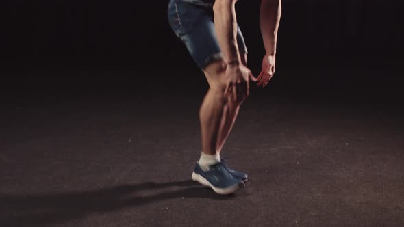 Young Pumpedup Guy in Denim Shorts Doing Stamina Exercises for His Body Jumps and Falls Down on His