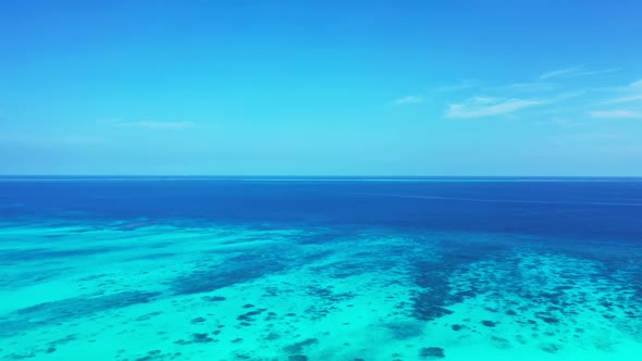 Aerial flying over landscape of beautiful coast beach break by shallow water and white sandy backgro