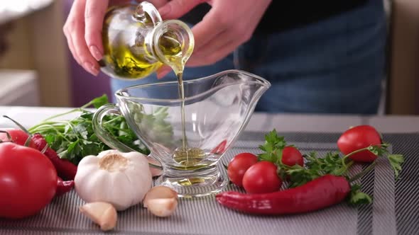Making Garlic Sauce  Pouring Olive Oil Into Glass Gravy Boat