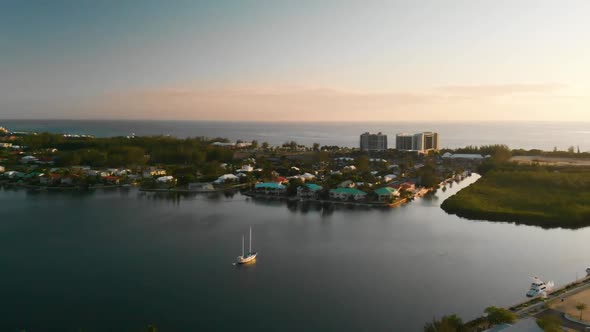 Drone flying near the Cayman Islands Yacht Club and marina at sunset
