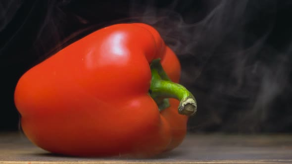 Sweet Red Bell Pepper or Capsicum Is on the Table in Cold, Steam From Frost in Slow Motion