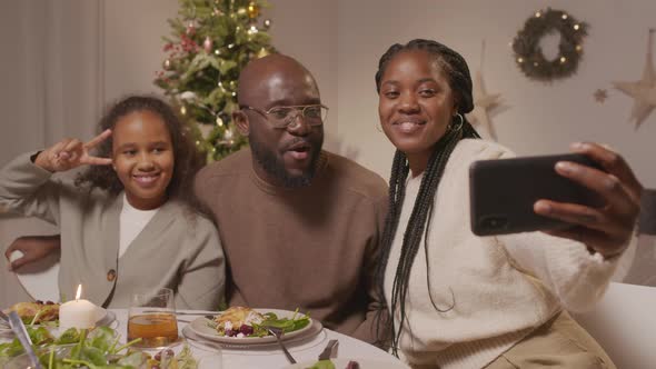 Happy Family Taking Selfie During Christmas Dinner