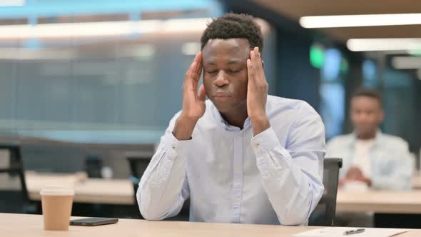 Tense African Businessman Having Headache