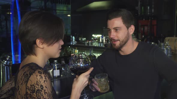 Happy Young Loving Couple Enjoying Drinks Togather at the Local Restaurant Bar