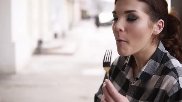 Close Up Footage of a Young Attractive Woman Enjoys Her Delicious Food
