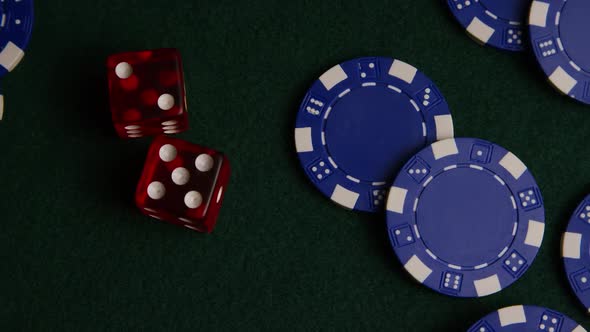 Rotating shot of poker cards and poker chips on a green felt surface - POKER 022