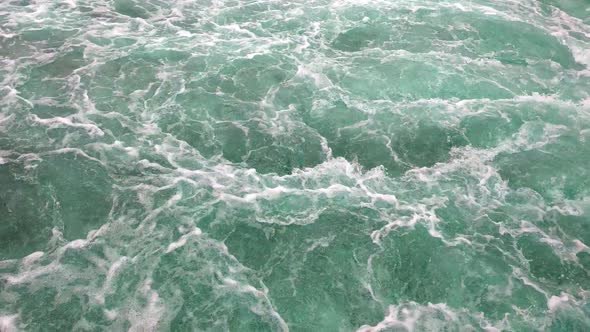 Top view of turquoise water. Large flow of water in a mountain river. Water splashes, splashes, foam