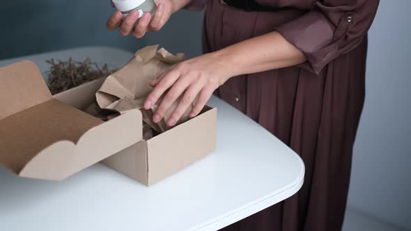 Woman Opening Parcel Indoors