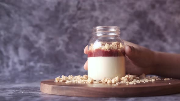 Women Hand Opens a Jar of Strawberry Cheese Cakes Parfait