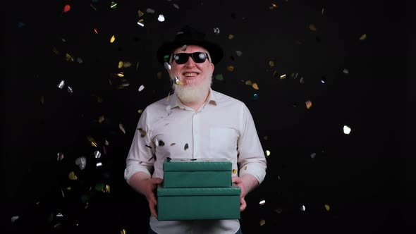 Colorful Confetti Falling Down in Front of an Albino Man with Gift Box in Hands