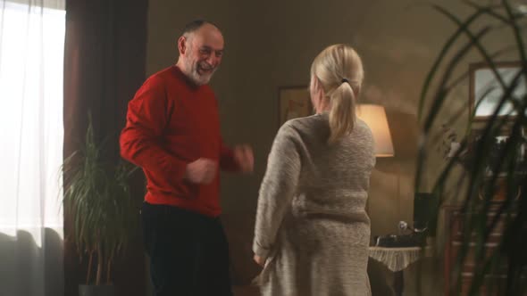 Energetic Aged Couple Dancing at Home