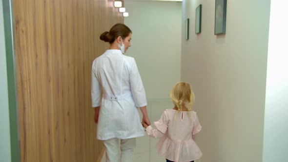 Doctor Walks with Girl Along the Corridor 