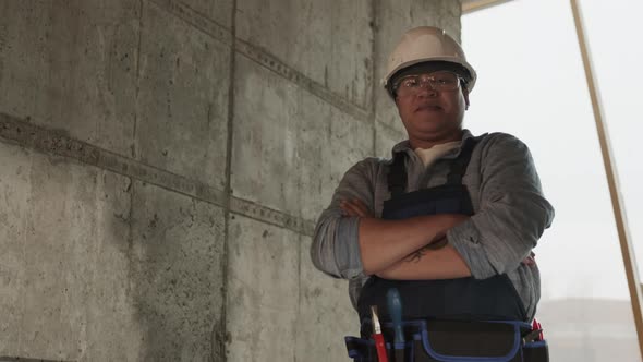 Mixed-Race Construction Worker in Helmet Posing