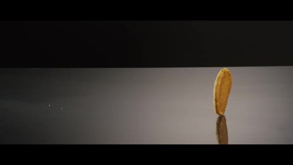 Falling cookies from above onto a reflective surface