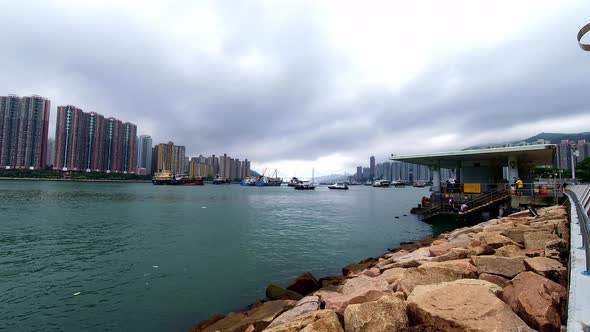 Ferryboats transporting people to and from Tsuen Wan ferry pier; time lapse