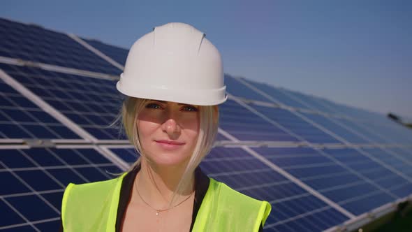 Portrait of Happy Female Engineer in Protective Helmet Crossing Arms While Looking to Camera