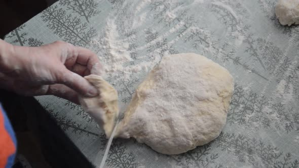 Woman sculpting bread cakes from flour