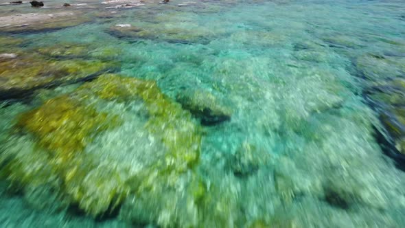 Flying low  above  clear turquoise sea water in Greece,  idyllic Elafonisi beach lagoon
